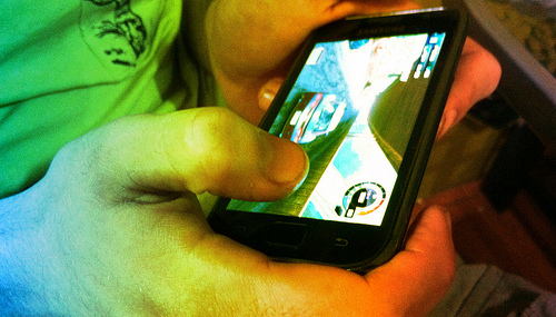 hands playing a mobile game