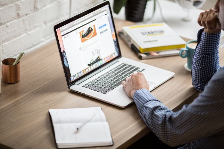 guy working on his laptop behind a desk