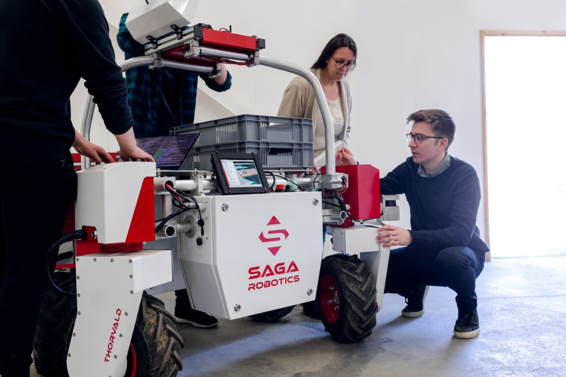 people setting up a robot