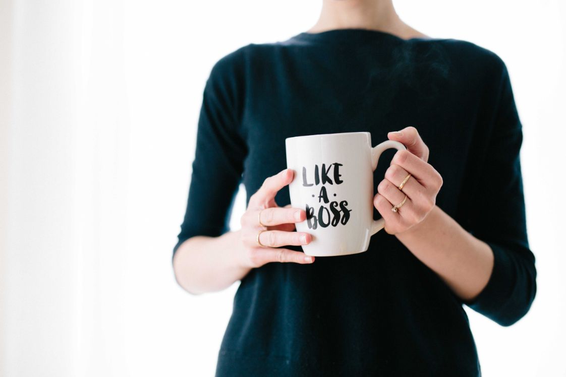 girl holding a boss mug