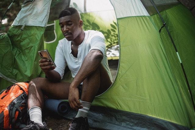 A boy using a smartphone while traveling